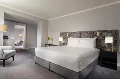 a living room with a table and chairs and a room at Hilton Prague Old Town in Prague