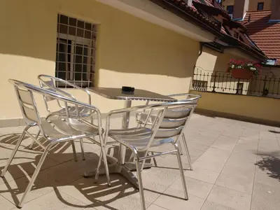 a table and chairs sitting on a patio at Hotel King George in Prague