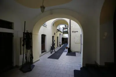 an alley with an archway in a building at Hotel King George in Prague