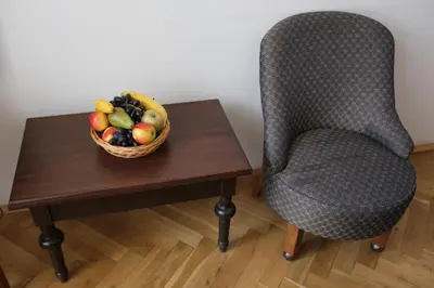 a bowl of fruit on a table with a chair at Hotel King George in Prague
