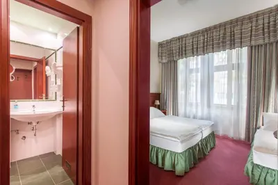 a bathroom with a sink and a mirror at Hotel Lunik in Prague