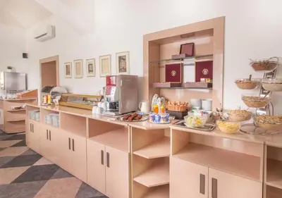 a kitchen with a counter with food on it at Hotel Lunik in Prague