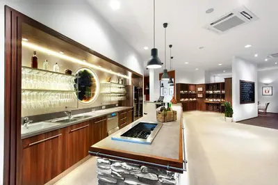a kitchen with a bar with wine glasses at Congress & Wellness Hotel Olsanka in Prague