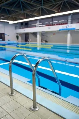 a swimming pool with a handrail in front of it at Congress & Wellness Hotel Olsanka in Prague