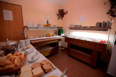 a kitchen with a table with food on it at Hotel Olga in Prague