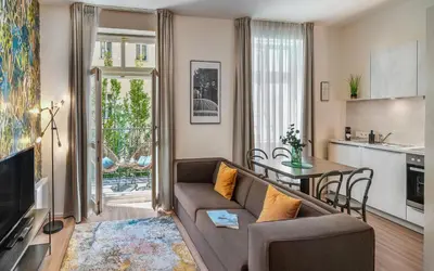 a living room with a couch and a table at VN48 Suites by Adrez in Prague