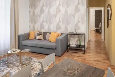 a living room with a couch and a table at VN48 Suites by Adrez in Prague
