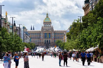 a group of people walking down a street in front of a building at VN48 Suites by Adrez in Prague