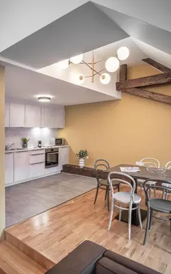 a kitchen and dining room with a table and chairs at VN48 Suites by Adrez in Prague