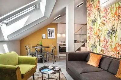 a living room with a couch and a table at VN48 Suites by Adrez in Prague
