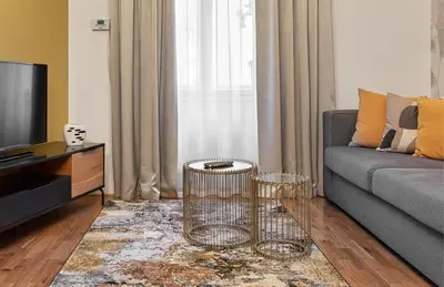 a living room with a couch and a tv at VN48 Suites by Adrez in Prague