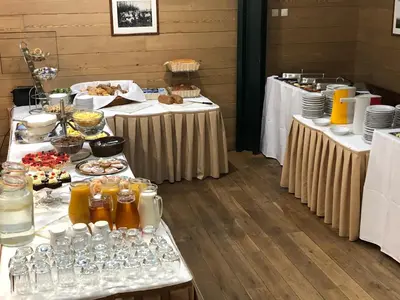 a buffet with two tables with food and drinks at U Medvidku-Brewery Hotel in Prague
