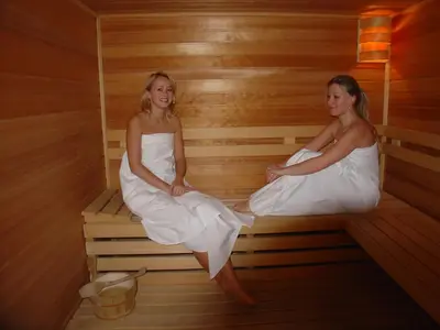 two women are sitting in a sauna at Hotel Opera in Prague