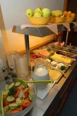 a buffet with a lot of food on a table at Hotel Opera in Prague