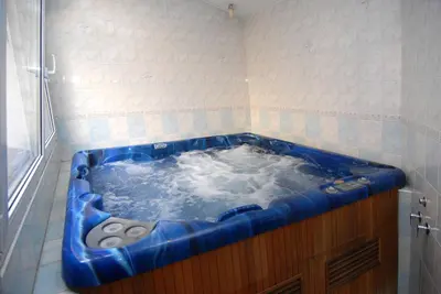 a large blue tub in a tiled bathroom at Hotel Opera in Prague