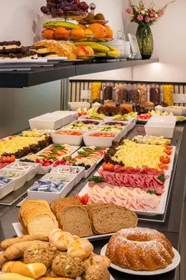 a buffet filled with lots of different types of food at Hotel Aida in Prague
