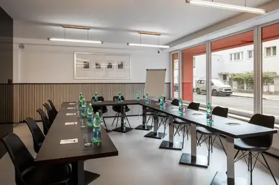 a conference room with a long table and chairs at Hotel Aida in Prague