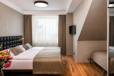 a hotel room with a bed and a window at Hotel Aida in Prague