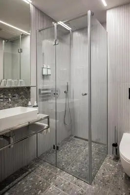 a bathroom with a shower and a sink and a toilet at Hotel Aida in Prague