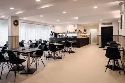 a restaurant with tables and chairs and a counter at Hotel Aida in Prague