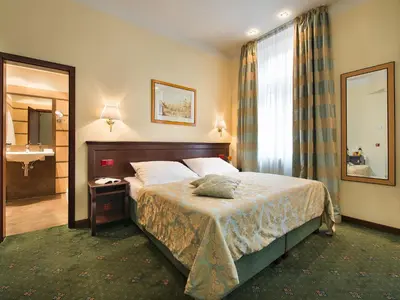a hotel room with a bed and a desk at EA Hotel Downtown in Prague