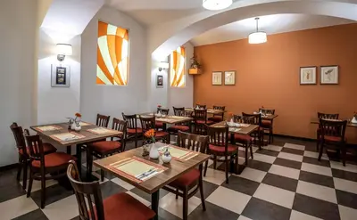 a restaurant with tables and chairs in a room at EA Hotel Downtown in Prague