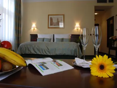 a bedroom with a bed and a table with wine glasses at EA Hotel Downtown in Prague