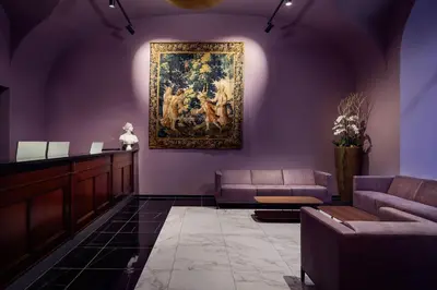 a living room with a painting hanging on the wall at Michelangelo Grand Hotel in Prague