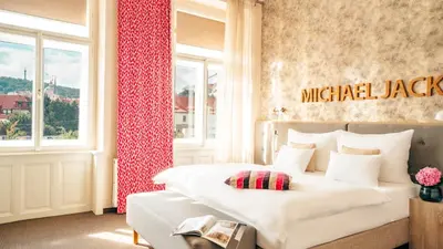 a hotel room with a bed and a window at Boutique Hotel Klarov in Prague