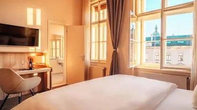 a hotel room with a bed and a window at Boutique Hotel Klarov in Prague