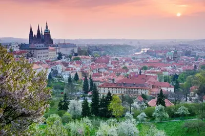 a view of a city at sunset at Hotel Questenberg in Prague