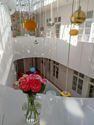 a vase with pink roses sitting on a table at LH Vintage Design Hotel Sax in Prague