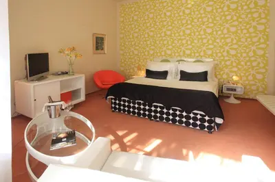 a bedroom with a bed and a glass table at LH Vintage Design Hotel Sax in Prague