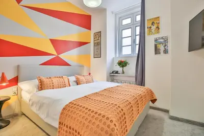 a bedroom with a bed with a painting on the wall at LH Vintage Design Hotel Sax in Prague