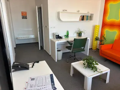 an office with a desk and a chair and a table at LH Vintage Design Hotel Sax in Prague