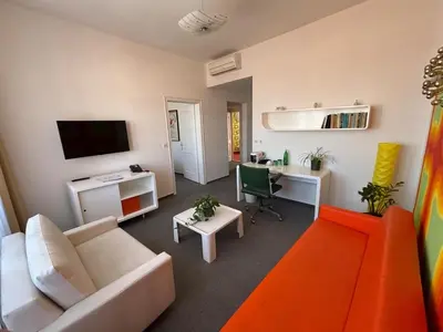 a living room with a white couch and a desk at LH Vintage Design Hotel Sax in Prague