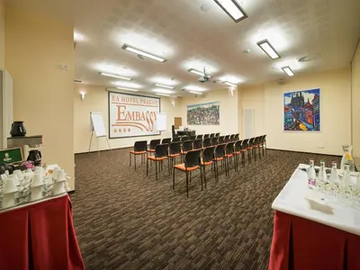 a conference room with chairs and a presentation in the background at EA Embassy Prague Hotel in Prague