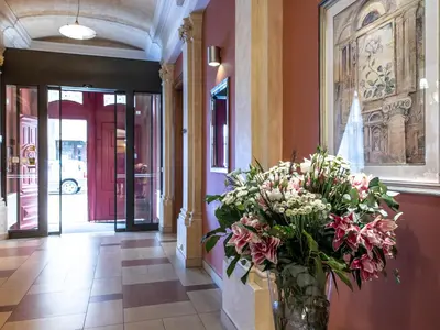 a vase filled with flowers in a hallway at EA Embassy Prague Hotel in Prague