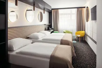 a row of beds in a hotel room at EA Embassy Prague Hotel in Prague