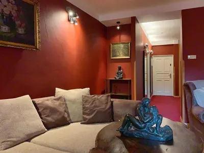 a living room with a couch with a statue on it at Small Luxury Palace Residence in Prague