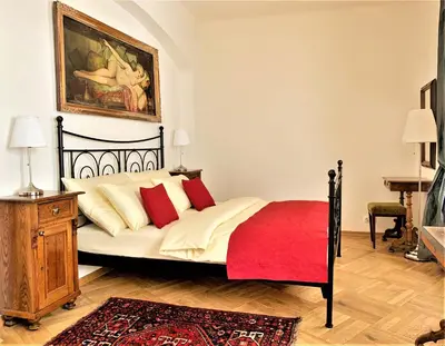 a bedroom with a bed and a painting on the wall at Small Luxury Palace Residence in Prague