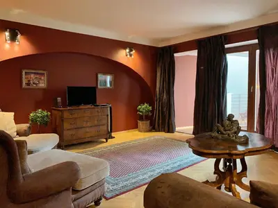 a living room with a couch and a tv at Small Luxury Palace Residence in Prague