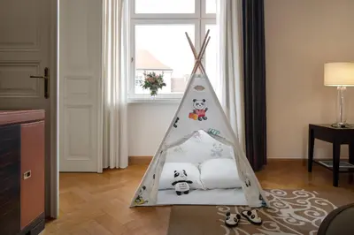 a childs bed in a room with a window at Mandarin Oriental, Prague in Prague