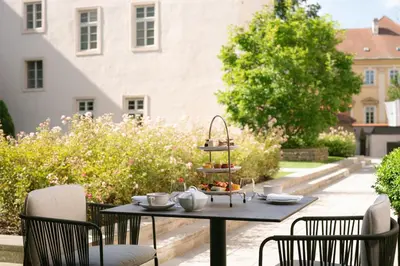 a table with a tray of food on a patio at Mandarin Oriental, Prague in Prague