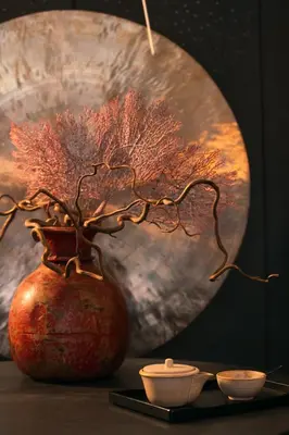 a vase with a plant in it sitting on a table at Mandarin Oriental, Prague in Prague