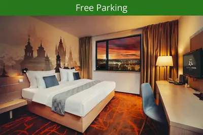 a hotel room with a bed and a desk and a window at Iris Hotel Eden - Czech Leading Hotels in Prague