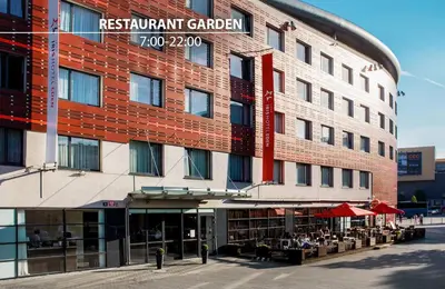 a red brick building with a restaurant in front of it at Iris Hotel Eden - Czech Leading Hotels in Prague