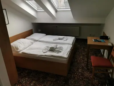 a bedroom with a bed with towels on it at City-Inn in Prague