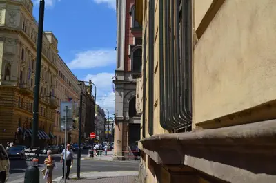 a couple of people walking down a city street at City-Inn in Prague
