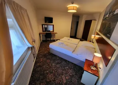 a hotel room with a bed and a desk at City-Inn in Prague